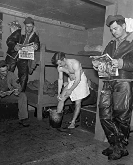 American army troops inside their packing case home getting ready for a night on the town