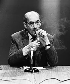 Microphones Prints: American comedy actor Groucho Marx smoking a cigar at a press conference in London