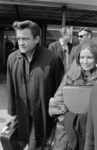 American country singer Johnny Cash with his wife June Carter arriving at Heathrow