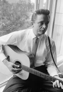 American country singer and musician Johnny Cash poses for photographers at the Savoy
