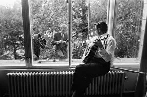 American country singer and musician Johnny Cash poses for photographers at the Savoy