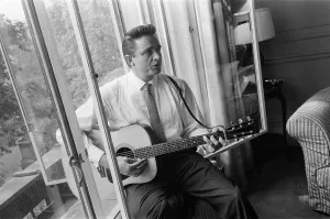 1959 Prints: American country singer and musician Johnny Cash poses for photographers at the Savoy