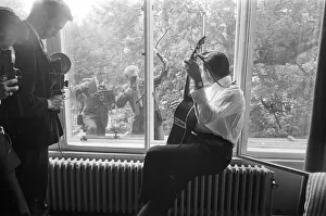 American country singer and musician Johnny Cash poses for photographers at the Savoy