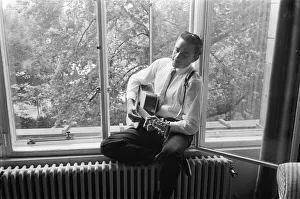 American country singer and musician Johnny Cash poses for photographers at the Savoy