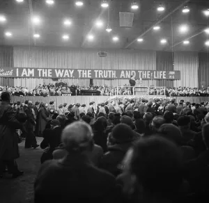 01163 Prints: American evangelist Billy Graham addressing a huge crowd of people at Kelvin Hall in