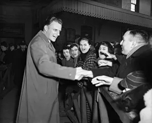 American evangelist Billy Graham salutes the huge crowd who gathered to welcome him