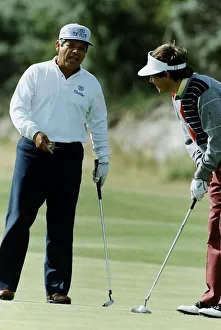 00189 Prints: American golfer Lee Trevino talking to another player who is about to take putt
