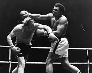 00129 Prints: American Heavyweight Champion of the World Muhammad Ali in action against Richard Dunn of