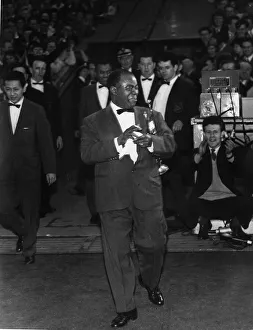 American jazz musician Louis Armstrong emerges from the players tunnel at Ibrox Stadium