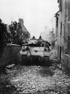 01449 Prints: An American M-10 tank destroyer of the US Army rambles along a debris strewn road near