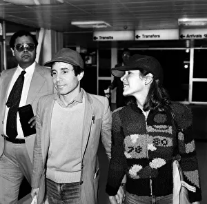 00724 Prints: American musician Paul Simon and actress Carrie Fisher at Heathrow airport. 24th May 1980
