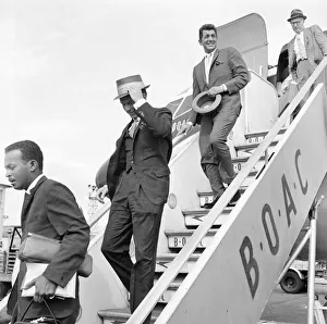 American musician and screen legend Frank Sinatra descends the steps of the plane as he