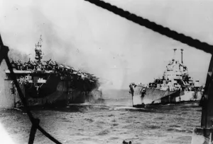 Us Navy Prints: An American Pacific Fleet cruiser pours steams of water into the stricken light aircraft