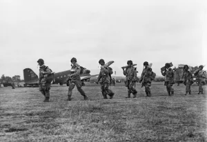 Allies Prints: American paratroopers file along with full equipment to board their transport plane for