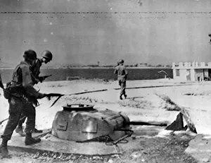 American patrol of the 7th Army passing a tank turret set in the street in St Raphael