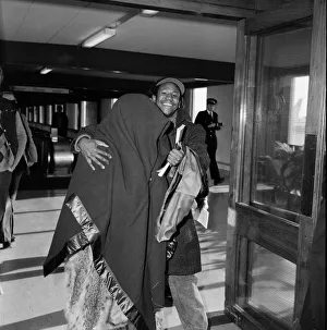 American pop artist Prince leaving Britain with a blanket over his head