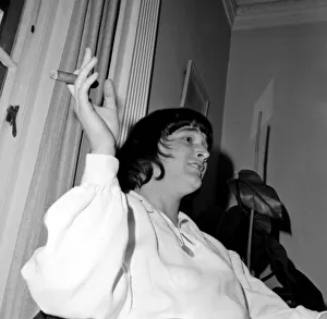 American pop singer P J Proby smokes a cigar at a press conference after he had been