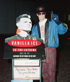 00285 Prints: American rapper Vanilla Ice at tHeathrow Airport with a cardboard cut out of himself to