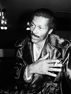 00329 Collection: American rock n roll singer Chuck Berry smoking a cigarette after a concert