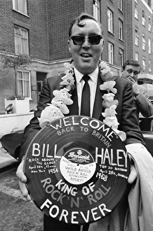 American rock and roll singer Bill Haley holds a record with a Welcome Back to Britain