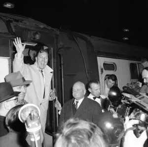 American rock and roll singer Bill Haley waves as he arrives in London for his UK tour