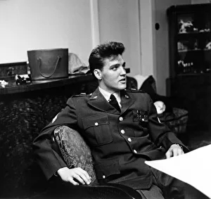 American rock and roll singer and musician Elvis Presley pictured wearing army uniform