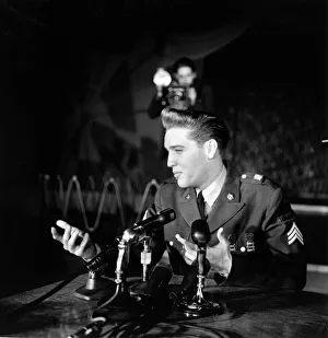 American rock and roll singer and musician Elvis Presley pictured wearing army uniform as