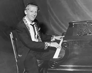 American rock and roll singer and musician Jerry Lee Lewis photgraphed sitting at his