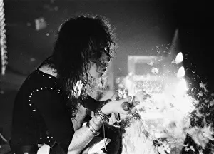 American rock singer Alice Cooper blows feathers nto the crowd during a concert in London