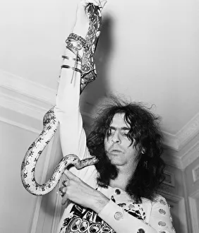 American rock singer Alice Cooper poses with his snake in London on his Love It To Death