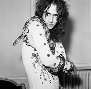 American rock singer Alice Cooper poses with his snake in London on his Love It To Death