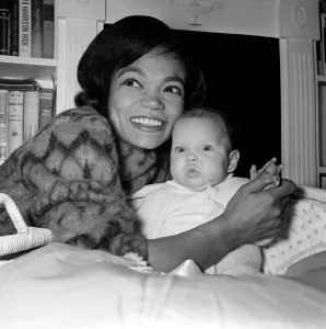 American singer and actress Eartha Kitt, photographed with her baby girl Kitt