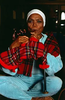 00097 Prints: American singer and actress Eartha Kitt blowing into bagpipes November 1989