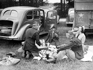American soldiers enjoy a picnic with their English girlfriends during a day out to watch