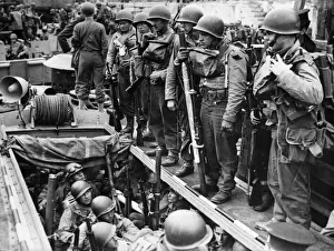 Ammunition Prints: American soldiers laden with equipment and weapons assemble on board a small landing