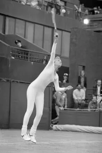 Bizarre Prints: American tennis player Anne White in action wearing her white skin tight catsuit during