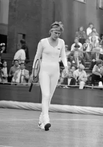 American tennis player Anne White in action wearing her white skin tight catsuit during