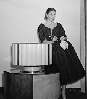 Amerivan actress Ava Gardner holding a cigarette holder at a press reception in London