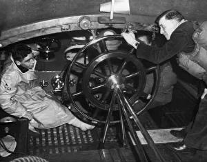 Andrew Mitchell (mechanic) chats with coxswain Gall in the wheelhouse of the Broughty