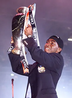 Treble Season Prints: Andy Cole celebrating with the League trophy May 1999 in Manchester Arena as