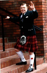 Andy Stewart singer waving going up steps Highland dress kilt Stewart of Bute tartan