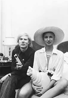 Andy Warhol with one of his leading ladies at a press conference to introduce his new