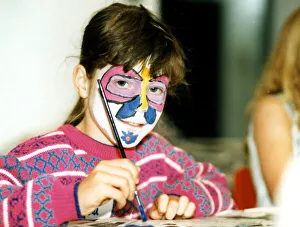 Brush Prints: Angela Collins with her face painted like a butterfly enjoys doing some painting