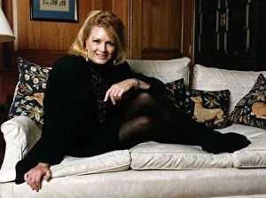 Angie Dickinson American Actress sitting with feet up on sofa