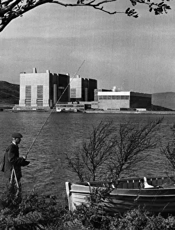 Gwynedd Prints: An angler weighs up his prospects in the shadow of Trawsfynydd in Snowdonia