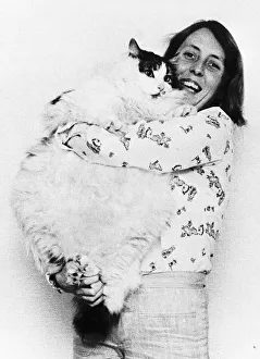 Size Prints: Animals Cats Gill Dacey struggles to hold up her pet pussy cat Tiger