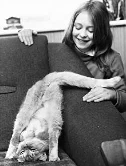 Animals - Cats A little girl watches her cat bend himself into unusual positions