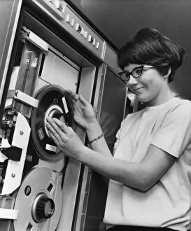 01000 Collection: Ann Boardman aged 20, changes a tape reel on the computer, Circa 1970