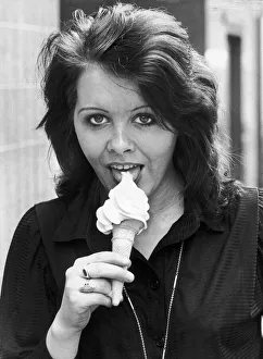 00421 Prints: Anne Alexander gives a suggestive lick to a creamy ice cream cone. 15th May 1980