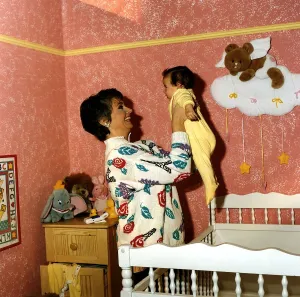 Anne Diamond cuddles tiny Clemency one of the babies used in the ad DBase